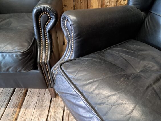 a pair of leather wingback armchairs seating armchairs
