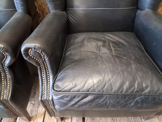 a pair of leather wingback armchairs seating armchairs