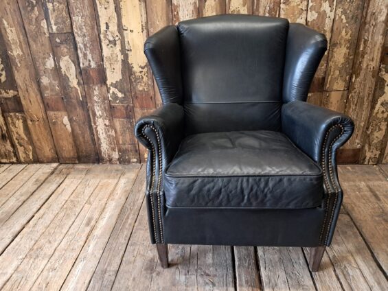 a pair of leather wingback armchairs seating armchairs