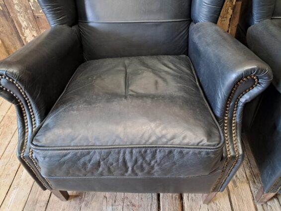 a pair of leather wingback armchairs seating armchairs