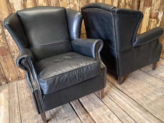 a pair of leather wingback armchairs seating armchairs