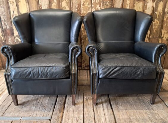 a pair of leather wingback armchairs seating armchairs