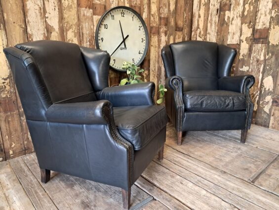 a pair of leather wingback armchairs seating armchairs