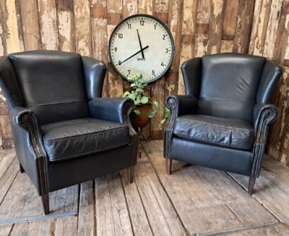 a pair of leather wingback armchairs seating armchairs