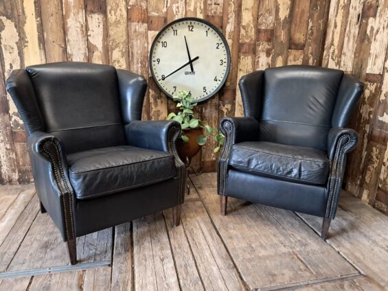 a pair of leather wingback armchairs seating armchairs