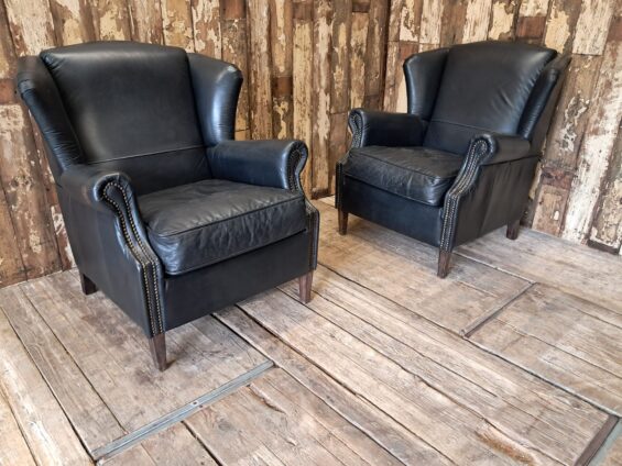 a pair of leather wingback armchairs seating armchairs
