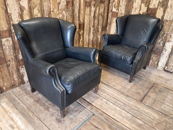 a pair of leather wingback armchairs seating armchairs
