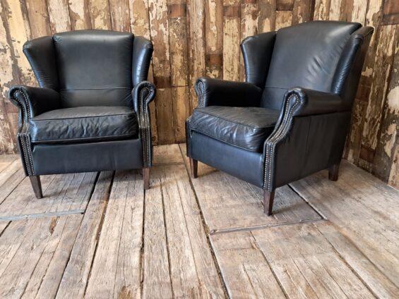 a pair of leather wingback armchairs seating armchairs