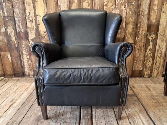 a pair of leather wingback armchairs seating armchairs