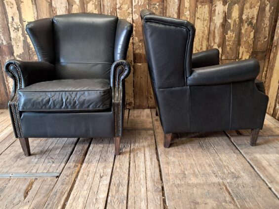 a pair of leather wingback armchairs seating armchairs