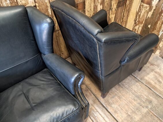 a pair of leather wingback armchairs seating armchairs