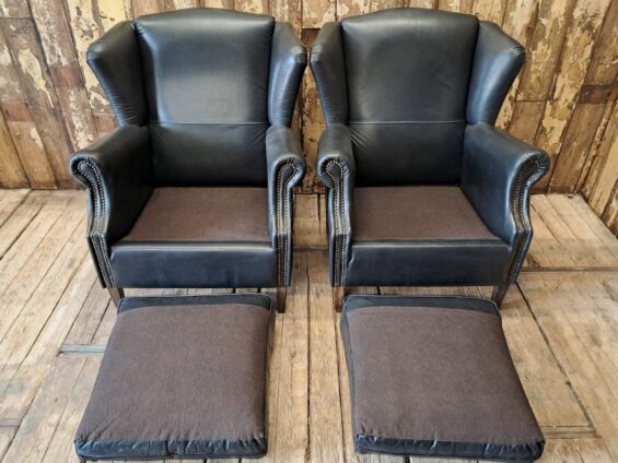 a pair of leather wingback armchairs seating armchairs