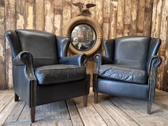 a pair of leather wingback armchairs seating armchairs