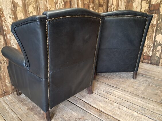 a pair of leather wingback armchairs seating armchairs