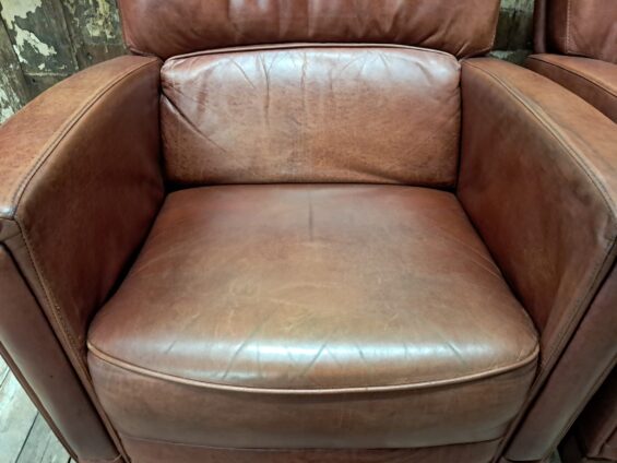 pair of leather club chairs seating armchairs