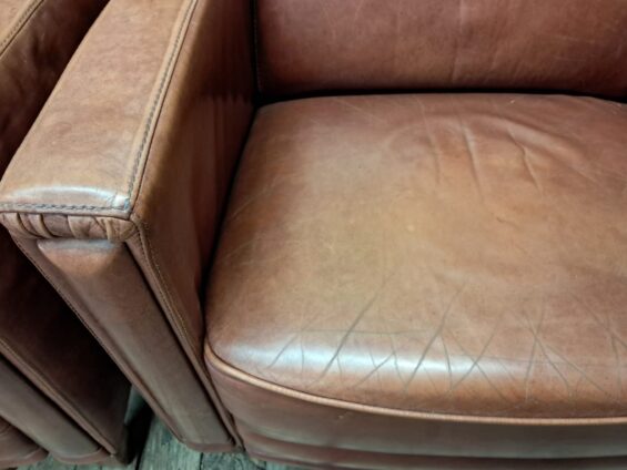 pair of leather club chairs seating armchairs