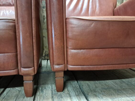 pair of leather club chairs seating armchairs