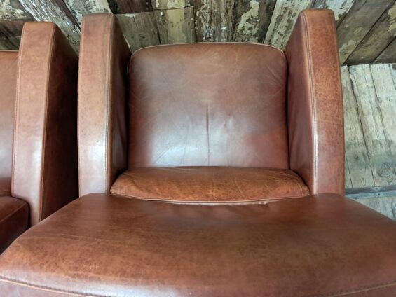 pair of leather club chairs seating armchairs